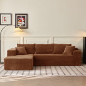Brown sectional sofa in a living room with framed art on the wall.