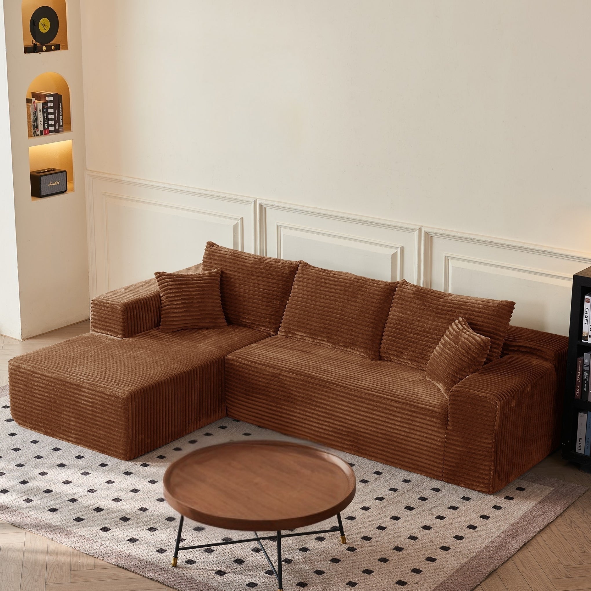 Brown sectional sofa in a living room with a round wooden coffee table.