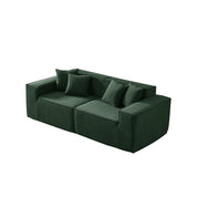 Green sofa with four cushions on a white background