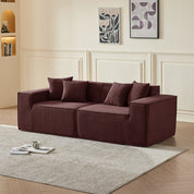 Brown sectional sofa in a living room with abstract art on the wall.